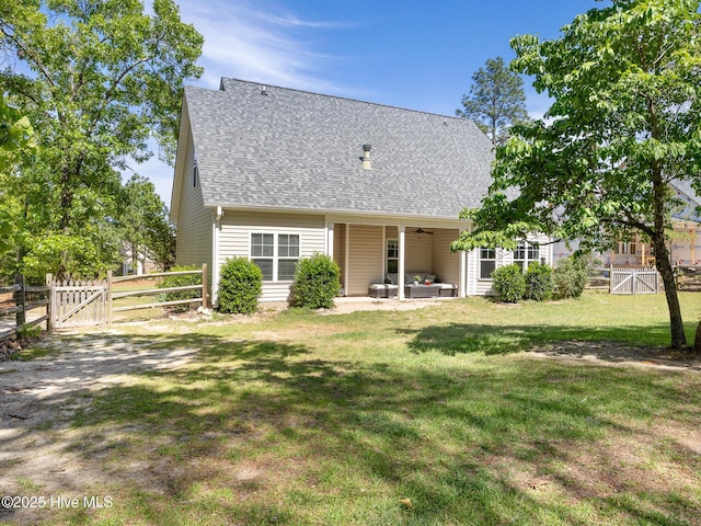 114 Schever Rd, West End, NC 27376 - back of house featuring a lawn, a shingled roof, a gate, and a fenced backyard