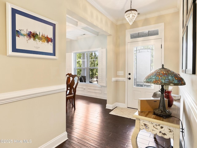 114 Schever Rd, West End, NC 27376 - entryway featuring dark wood-style flooring, an inviting chandelier, beam ceiling, baseboards, and ornamental molding