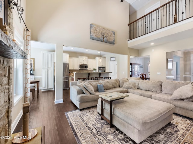 114 Schever Rd, West End, NC 27376 - living area with dark wood-type flooring, baseboards, and a high ceiling