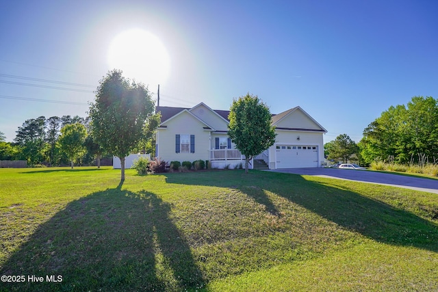 single story home featuring driveway, a front yard, and a garage