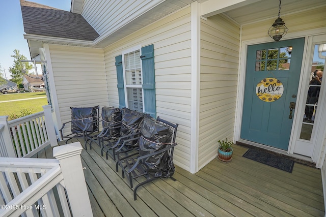 doorway to property with a shingled roof