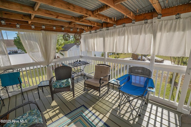 wooden deck featuring an outdoor structure and a storage unit
