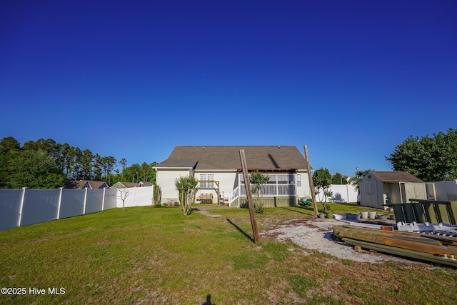 view of yard featuring an outdoor structure, a deck, a fenced backyard, a shed, and stairway
