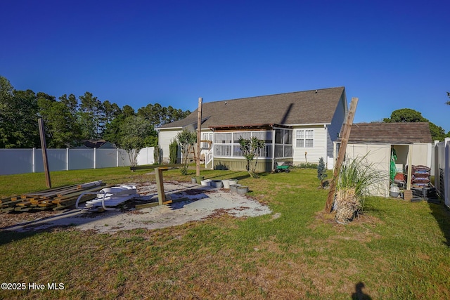 back of house with fence, a storage unit, an outdoor structure, and a yard