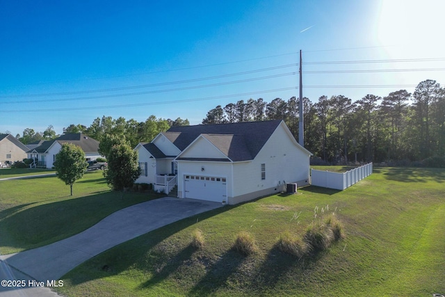 view of front of house with a garage, central air condition unit, driveway, and a front yard