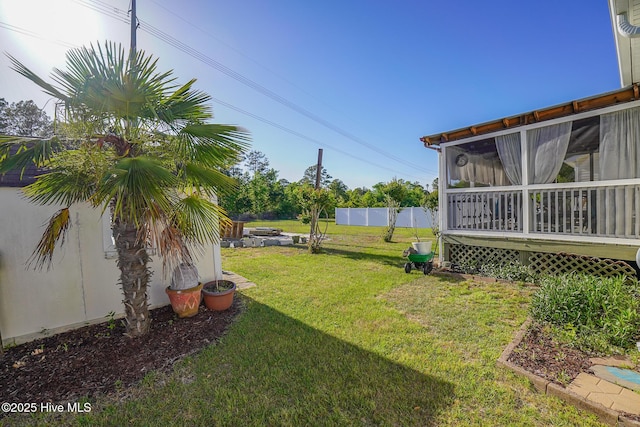 view of yard featuring a sunroom and fence