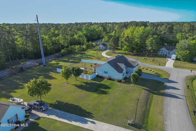 birds eye view of property featuring a wooded view