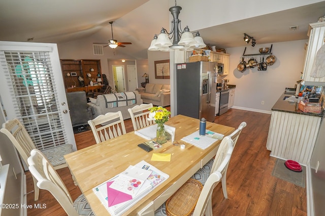 dining area with visible vents, lofted ceiling, baseboards, dark wood-type flooring, and ceiling fan with notable chandelier