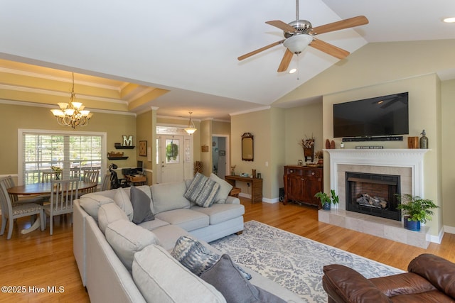 95 Glen Cove Ln, West End, NC 27376 - living area with ornamental molding, a ceiling fan, vaulted ceiling, a tiled fireplace, and a chandelier