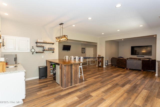 kitchen featuring a sink, recessed lighting, white cabinets, and dark wood-style flooring