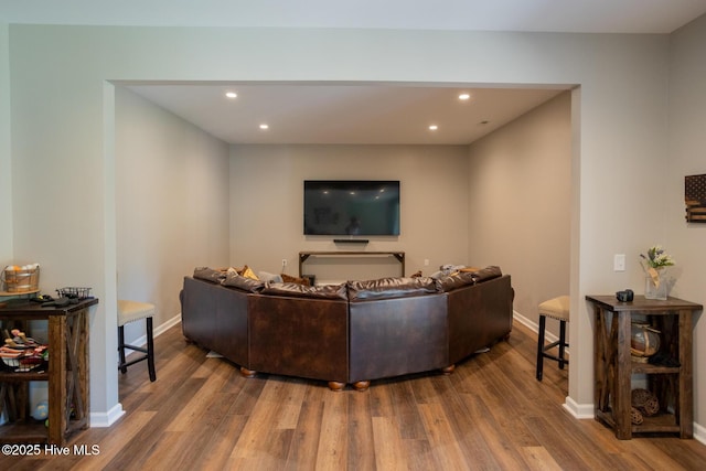 living room featuring recessed lighting, baseboards, and wood finished floors