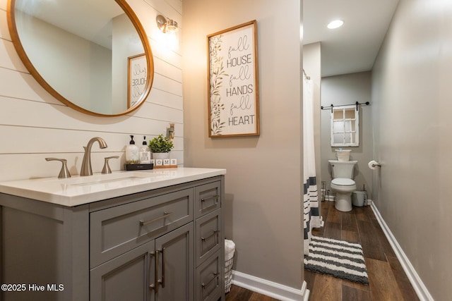 full bathroom featuring vanity, wood finished floors, curtained shower, toilet, and baseboards