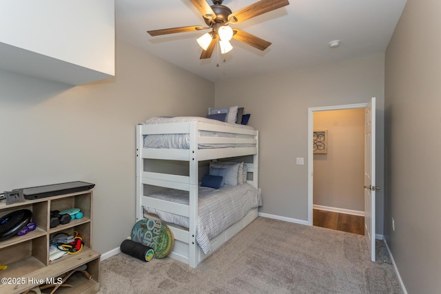 carpeted bedroom featuring baseboards and ceiling fan