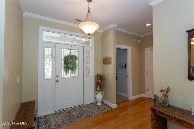 foyer entrance featuring visible vents, ornamental molding, light wood-style floors, baseboards, and recessed lighting