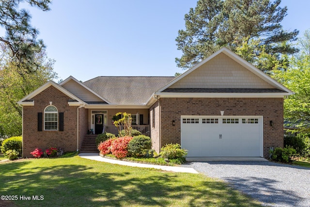 95 Glen Cove Ln, West End, NC 27376 - ranch-style house with driveway, brick siding, a front yard, and covered porch
