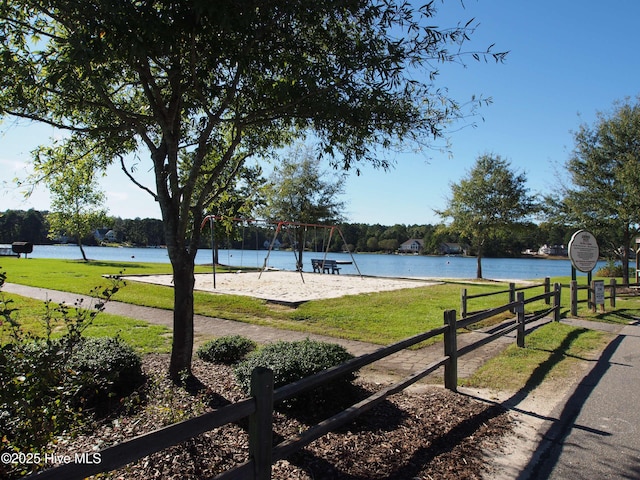 exterior space featuring a water view, a yard, and playground community