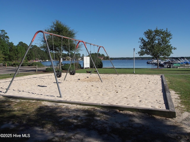view of property's community with a water view and playground community