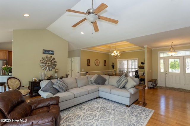 living room featuring crown molding, vaulted ceiling, ceiling fan with notable chandelier, light wood finished floors, and recessed lighting