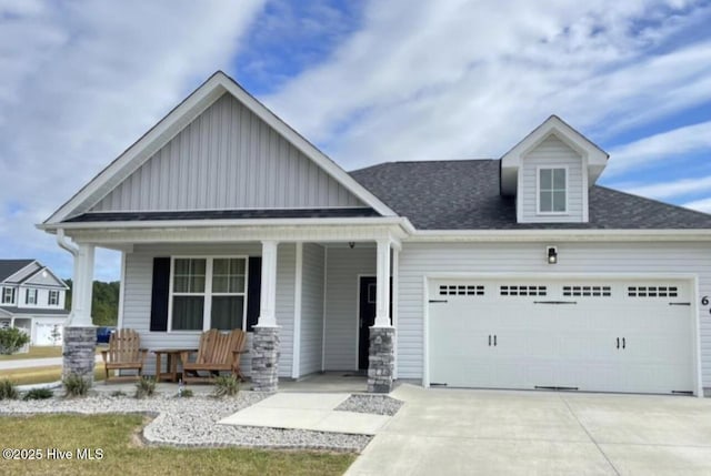 604 Winfall Dr, Holly Ridge, NC 28445 - craftsman house with covered porch, board and batten siding, a garage, driveway, and roof with shingles