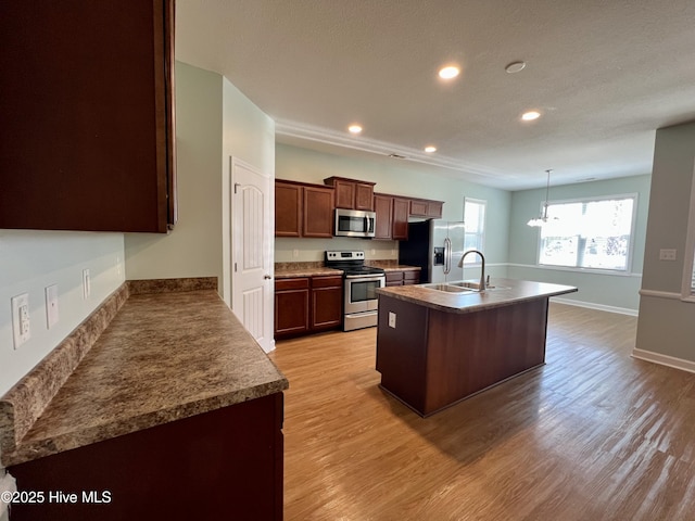 604 Winfall Dr, Holly Ridge, NC 28445 - kitchen with stainless steel appliances, light wood-style floors, recessed lighting, a sink, and an island with sink
