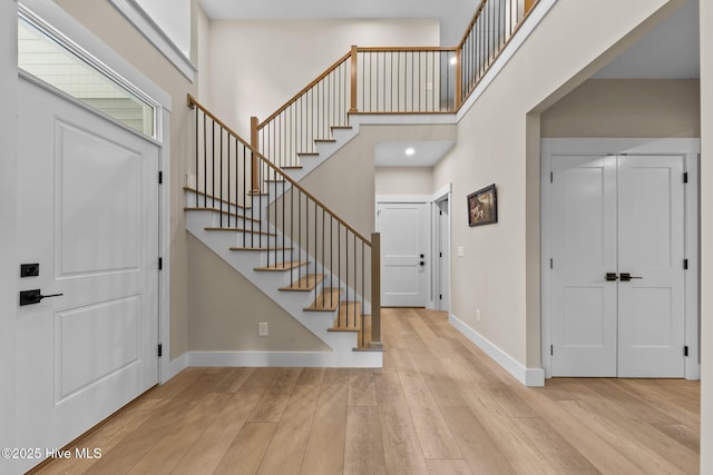 44 S Shamrock Dr, Foxfire Village, NC 27281 - foyer entrance with light wood-style flooring, a high ceiling, baseboards, and stairway