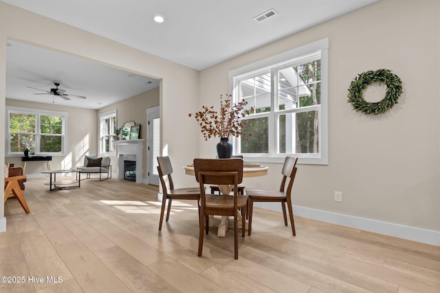 44 S Shamrock Dr, Foxfire Village, NC 27281 - dining room featuring light wood-style floors, baseboards, recessed lighting, ceiling fan, and a glass covered fireplace