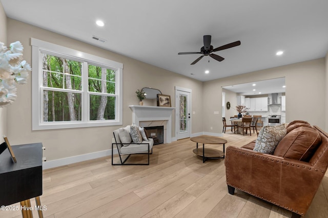 44 S Shamrock Dr, Foxfire Village, NC 27281 - living area with light wood finished floors, a high end fireplace, ceiling fan, baseboards, and recessed lighting
