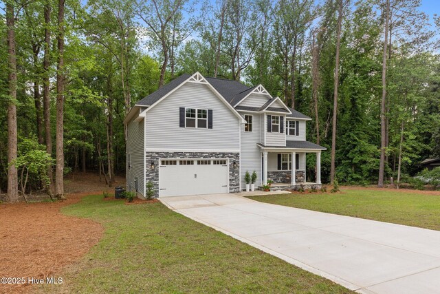 44 S Shamrock Dr, Foxfire Village, NC 27281 - craftsman inspired home featuring driveway, covered porch, an attached garage, stone siding, and a front yard