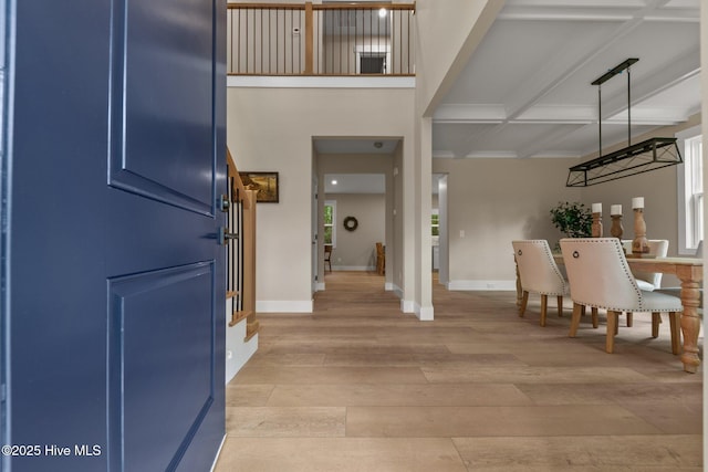 44 S Shamrock Dr, Foxfire Village, NC 27281 - entrance foyer featuring light wood finished floors, beamed ceiling, baseboards, coffered ceiling, and crown molding