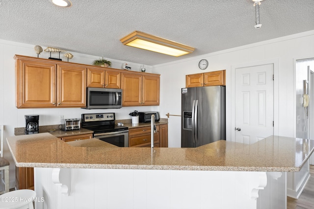 kitchen featuring a sink, a textured ceiling, and stainless steel fridge with ice dispenser