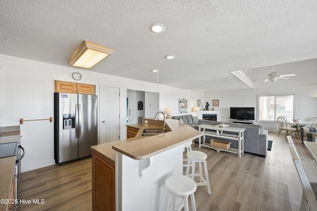 dining room featuring a water view, baseboards, a chandelier, and light wood-style flooring
