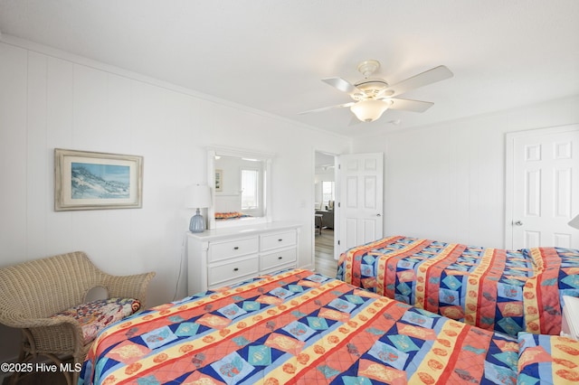 bedroom featuring crown molding, a ceiling fan, visible vents, and carpet