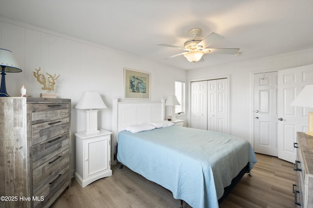 bedroom with crown molding, ceiling fan, and wood finished floors