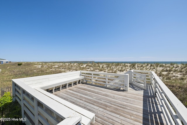 balcony featuring a beach view and a water view