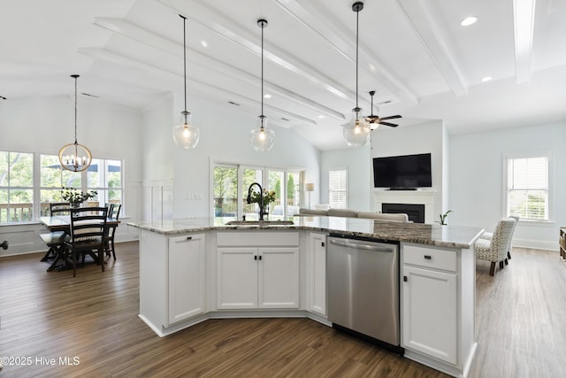 kitchen featuring a sink, a fireplace, dishwasher, ceiling fan with notable chandelier, and open floor plan