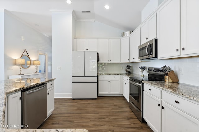 kitchen with decorative backsplash, visible vents, crown molding, appliances with stainless steel finishes, and white cabinets