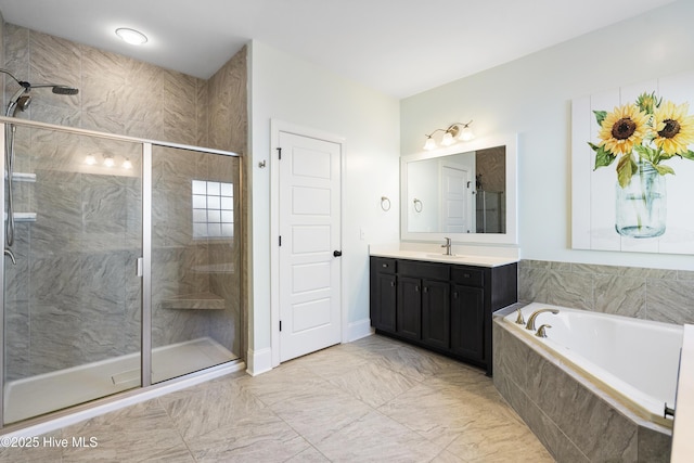 bathroom featuring vanity, baseboards, a stall shower, and a bath