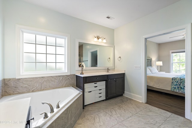 ensuite bathroom with vanity, a garden tub, connected bathroom, and visible vents