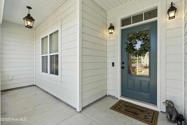 view of exterior entry featuring covered porch