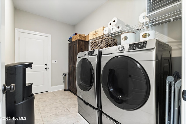 clothes washing area with laundry area, marble finish floor, and washing machine and dryer