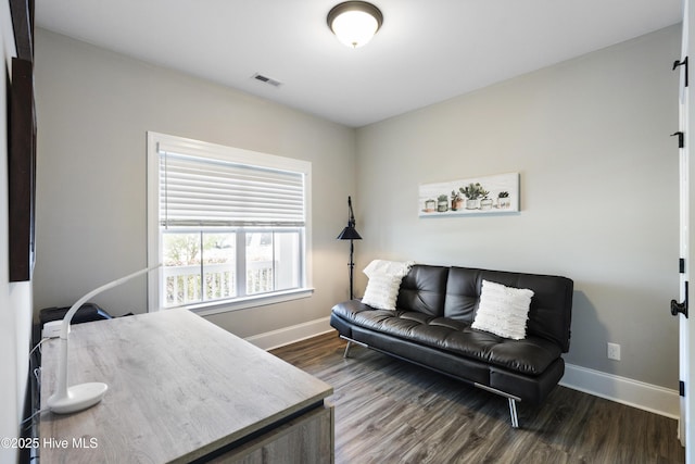 office area with baseboards, visible vents, and dark wood finished floors