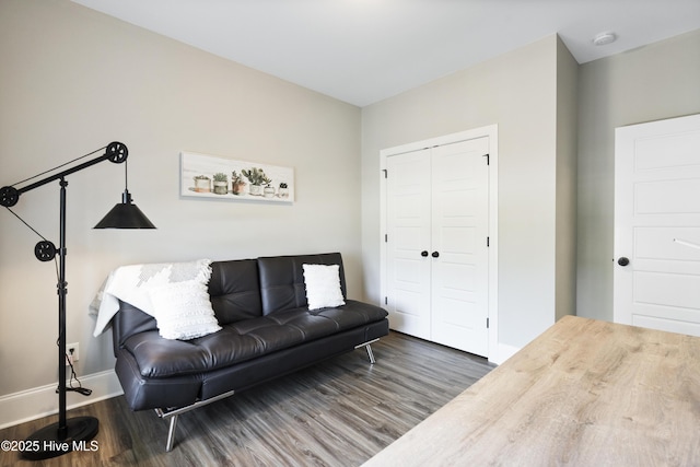 living area featuring baseboards and wood finished floors