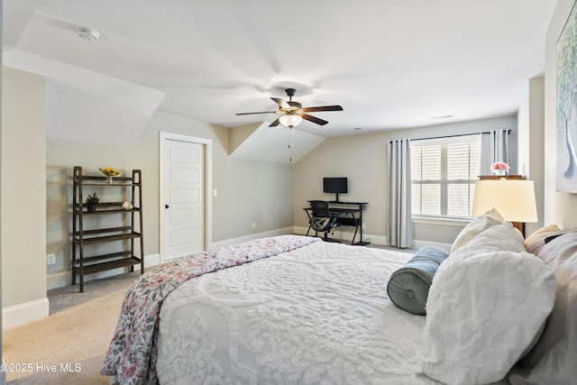 carpeted bedroom with baseboards, a ceiling fan, and vaulted ceiling