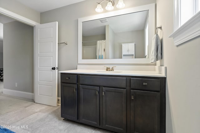 bathroom featuring vanity and curtained shower