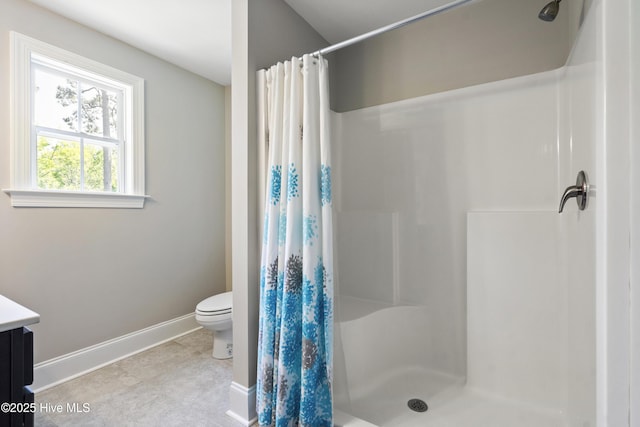 full bath featuring baseboards, vanity, toilet, and a shower stall