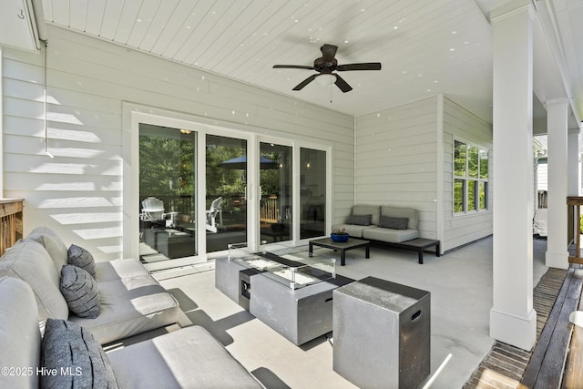 view of patio with an outdoor living space and a ceiling fan