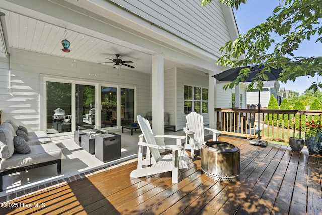 deck featuring an outdoor living space and a ceiling fan
