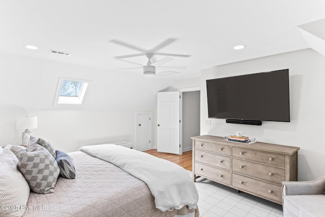 bedroom with recessed lighting, ceiling fan, visible vents, and vaulted ceiling with skylight