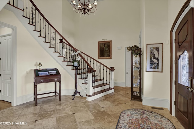 2220 Bel Arbor Pl, Wilmington, NC 28403 - entrance foyer with a towering ceiling, a chandelier, and stairs