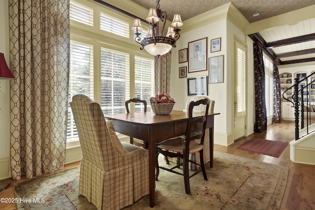 2220 Bel Arbor Pl, Wilmington, NC 28403 - dining room with a chandelier, wood finished floors, stairway, and ornamental molding